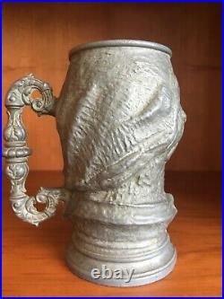 Beautiful Antique and rare decorative tin mug with human head reliefs